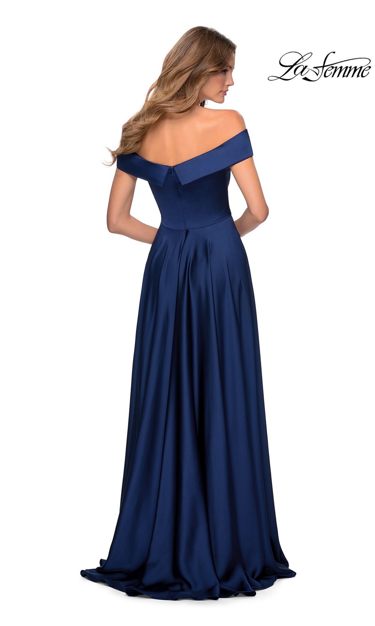 A woman is seen from the back in a navy blue La Femme Off-Shoulder Long A-Line Prom Dress 28978, featuring a fitted bodice and flowing floor-length skirt.